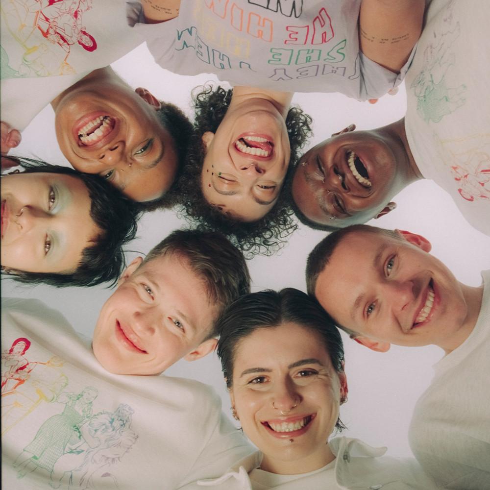 Group of people in a circle smiling