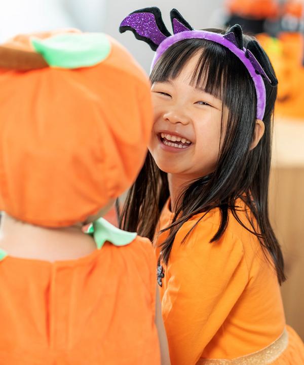 Child wears pumpkin tutu dress