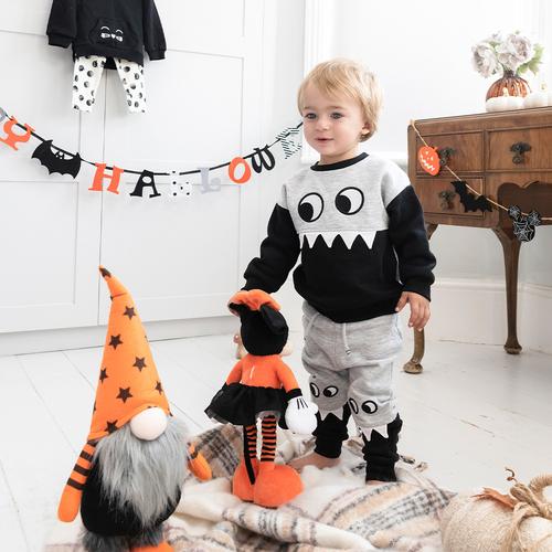 Child wears black and grey monster set