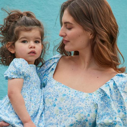 Mother and daughter models wear matching blue floral dresses