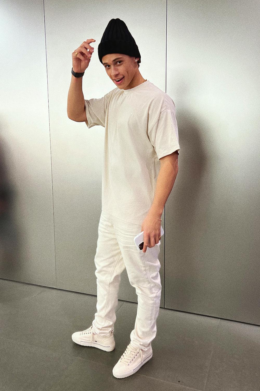 Ethan in beanie, white jeans, T-shirt