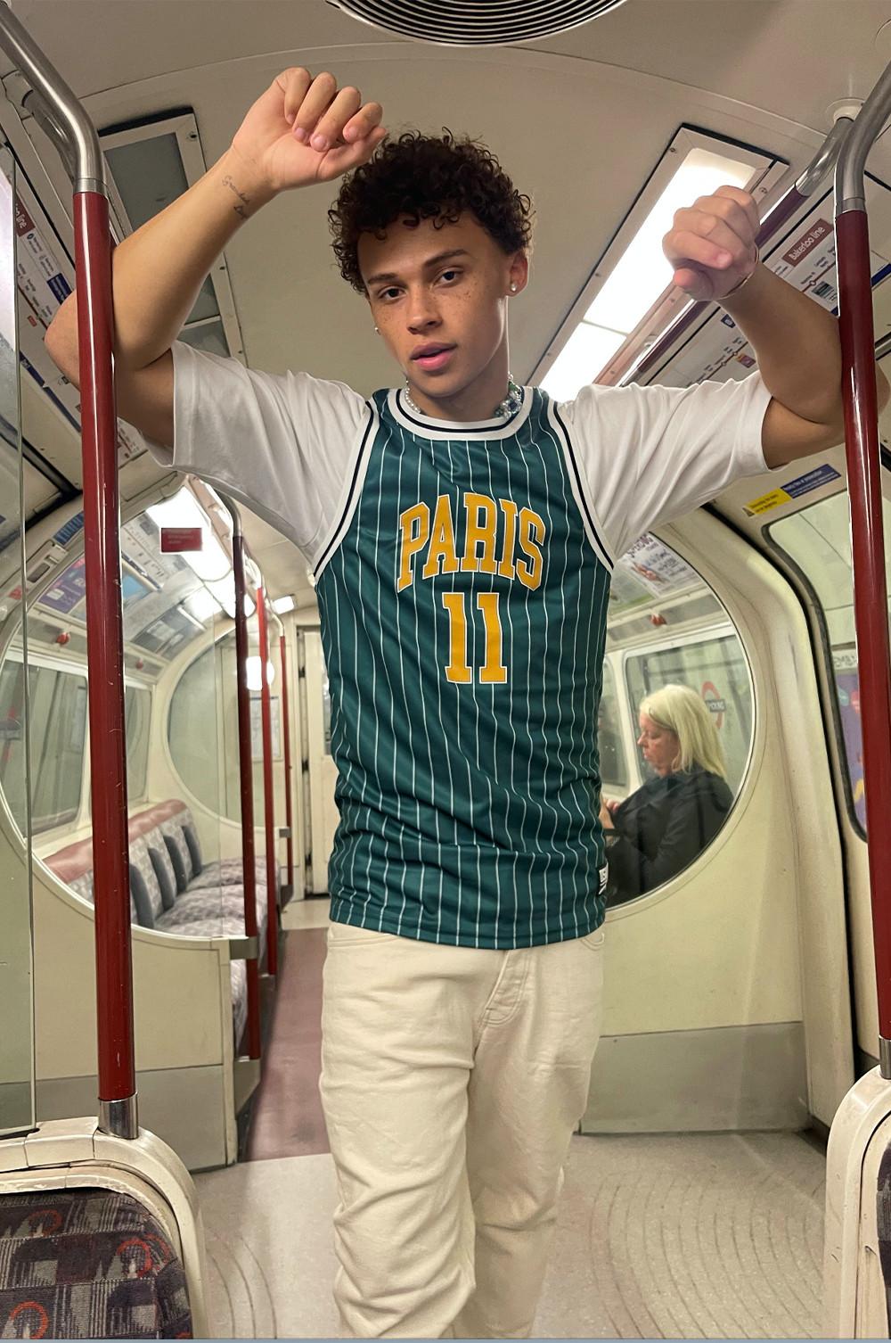 Ethan con una camiseta deportiva sin mangas y vaqueros