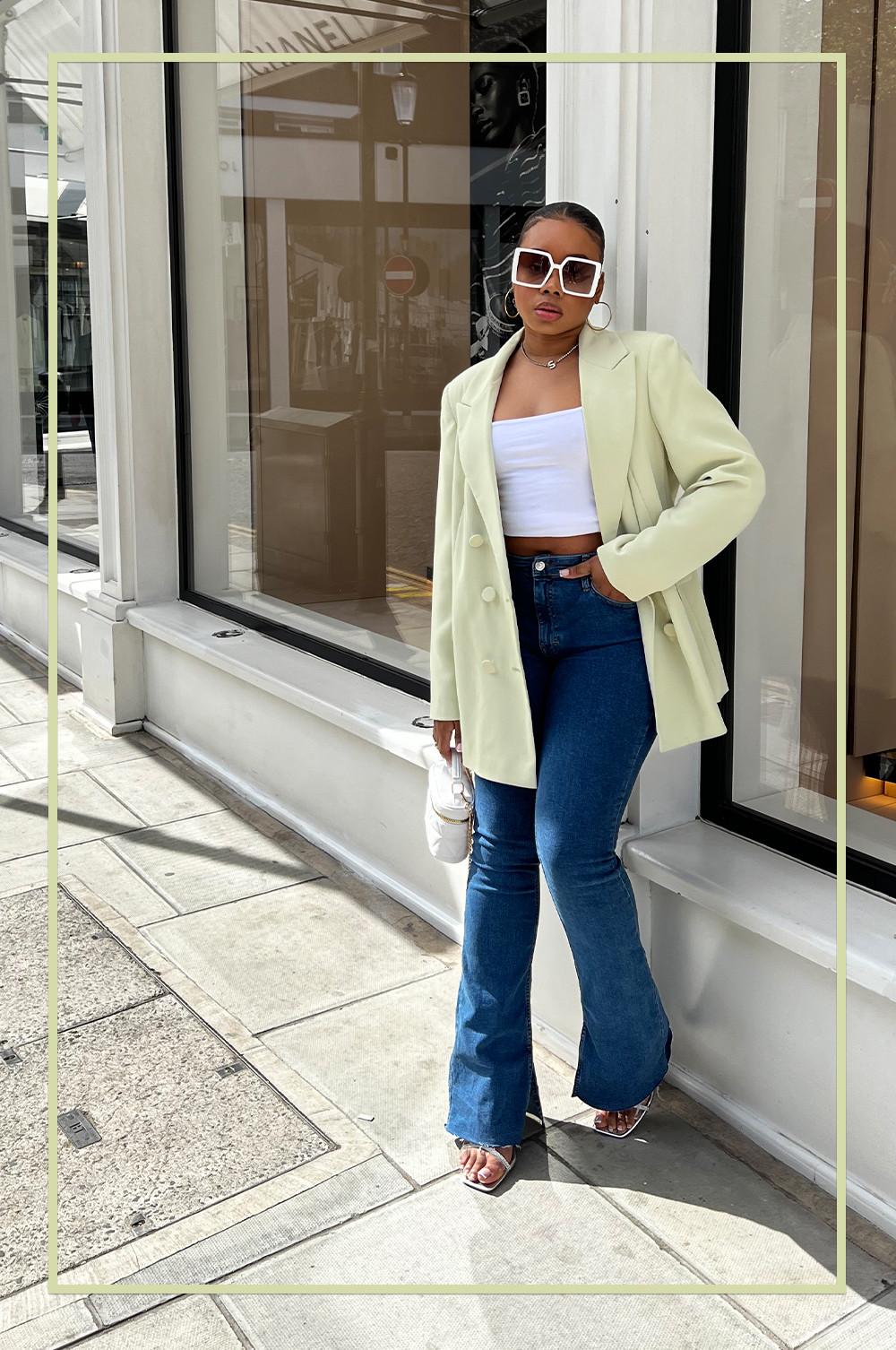 @sharayethomas wearing green blazer, blue flared jeans and white top