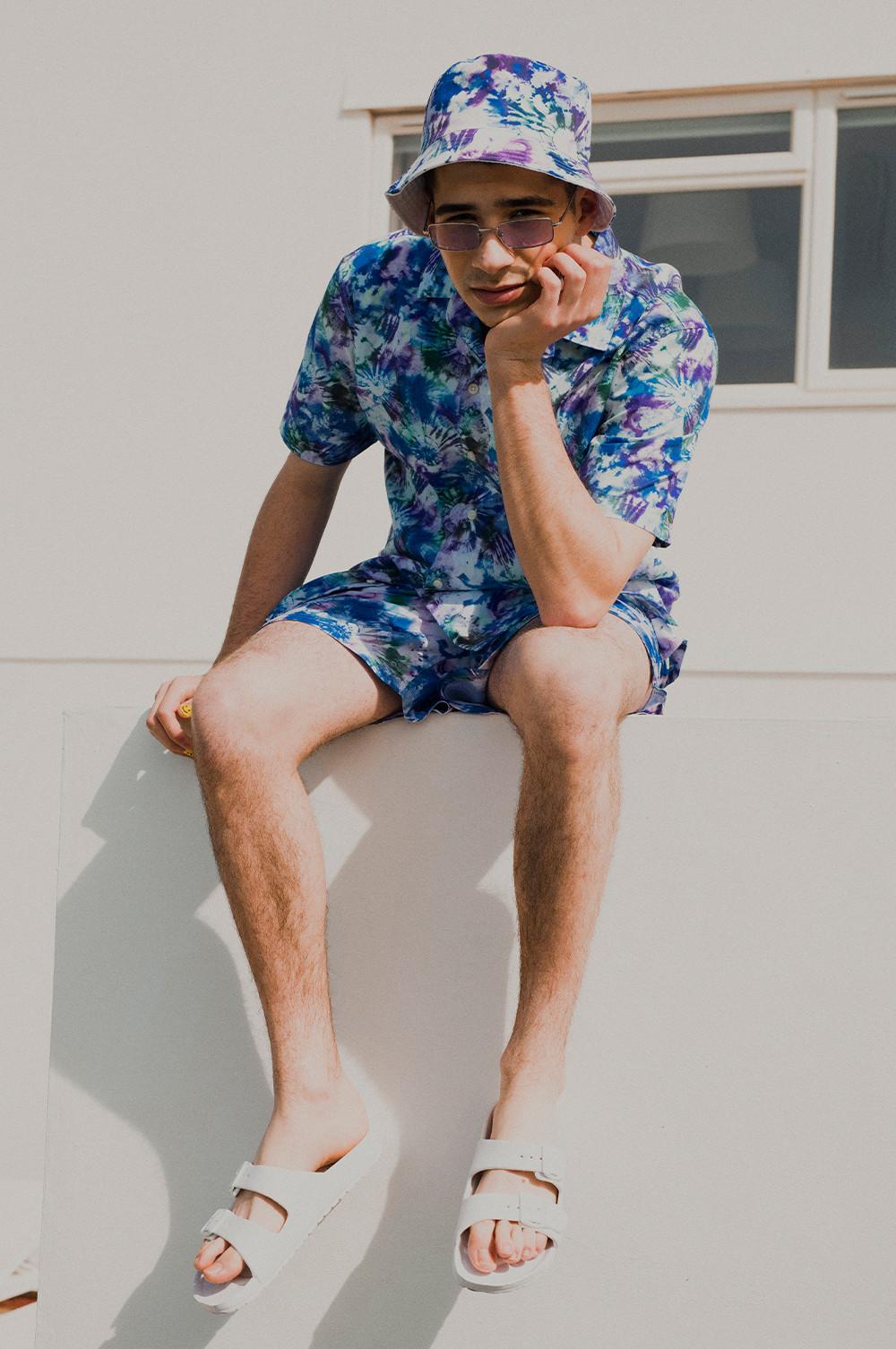 Man wearing tie die co-ord and bucket hat