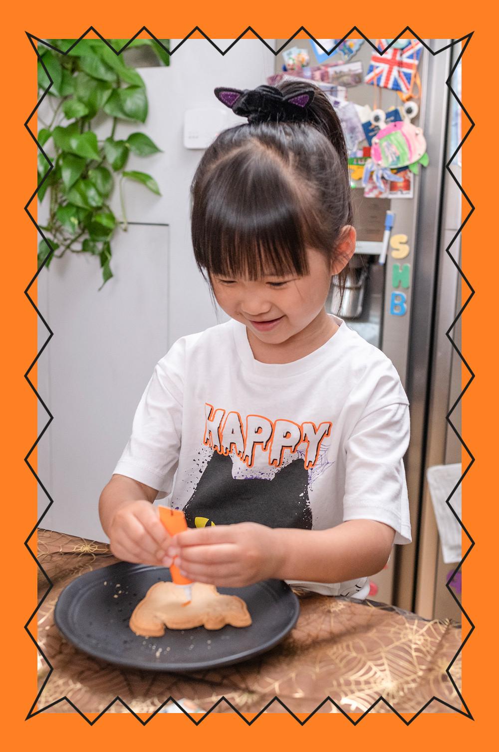 Child wears halloween top with cat ear scrunchie