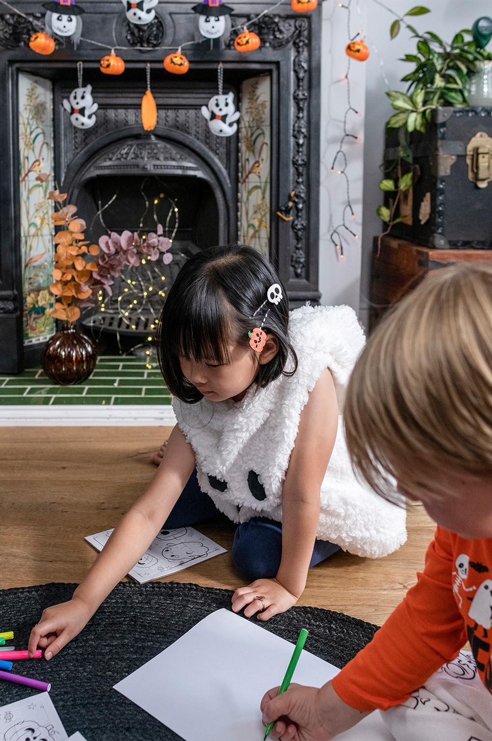 Child wears plush ghost bodysuit