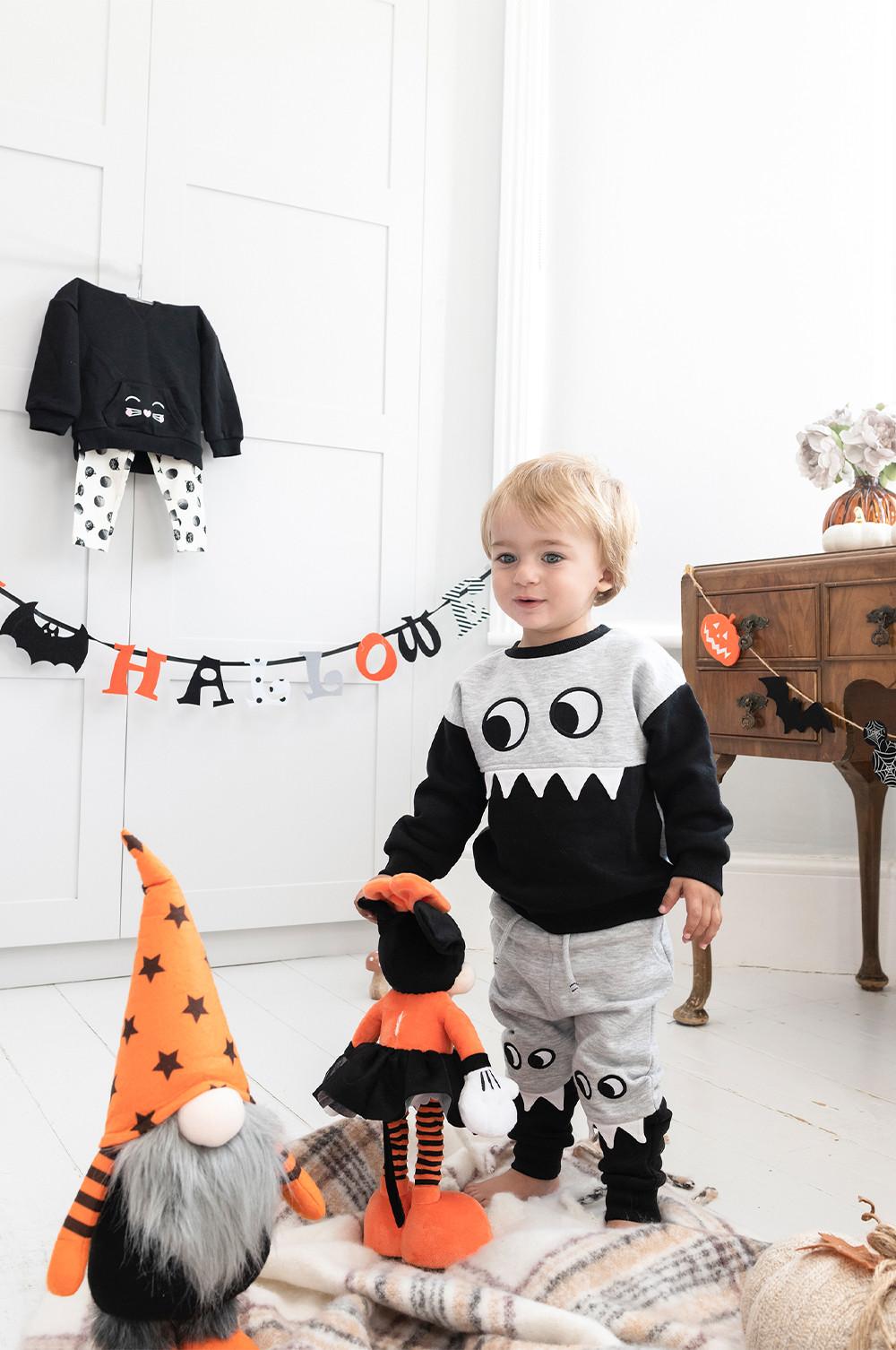 Child wears grey and black monster set