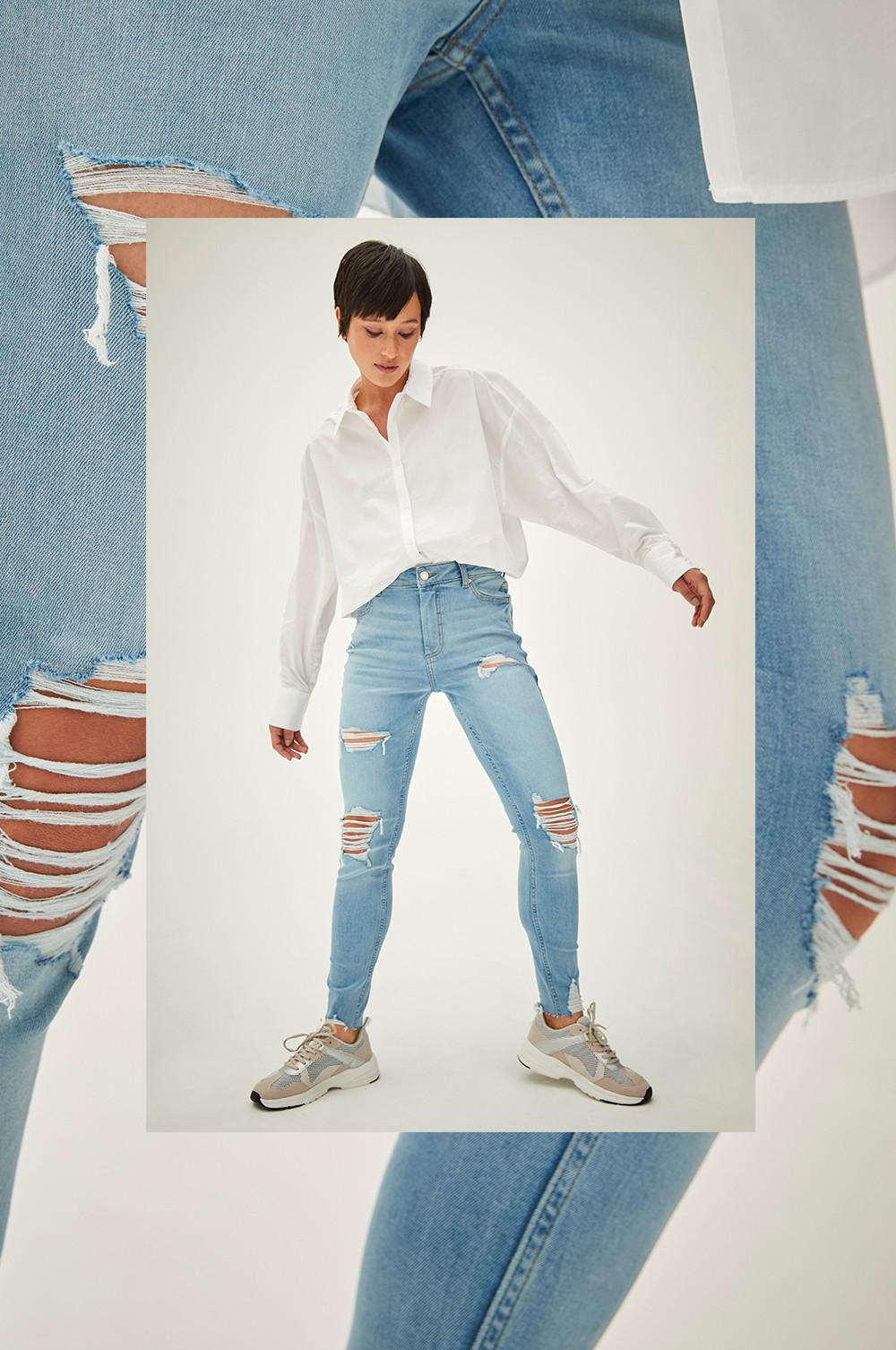 Model wears ripped skinny jeans
