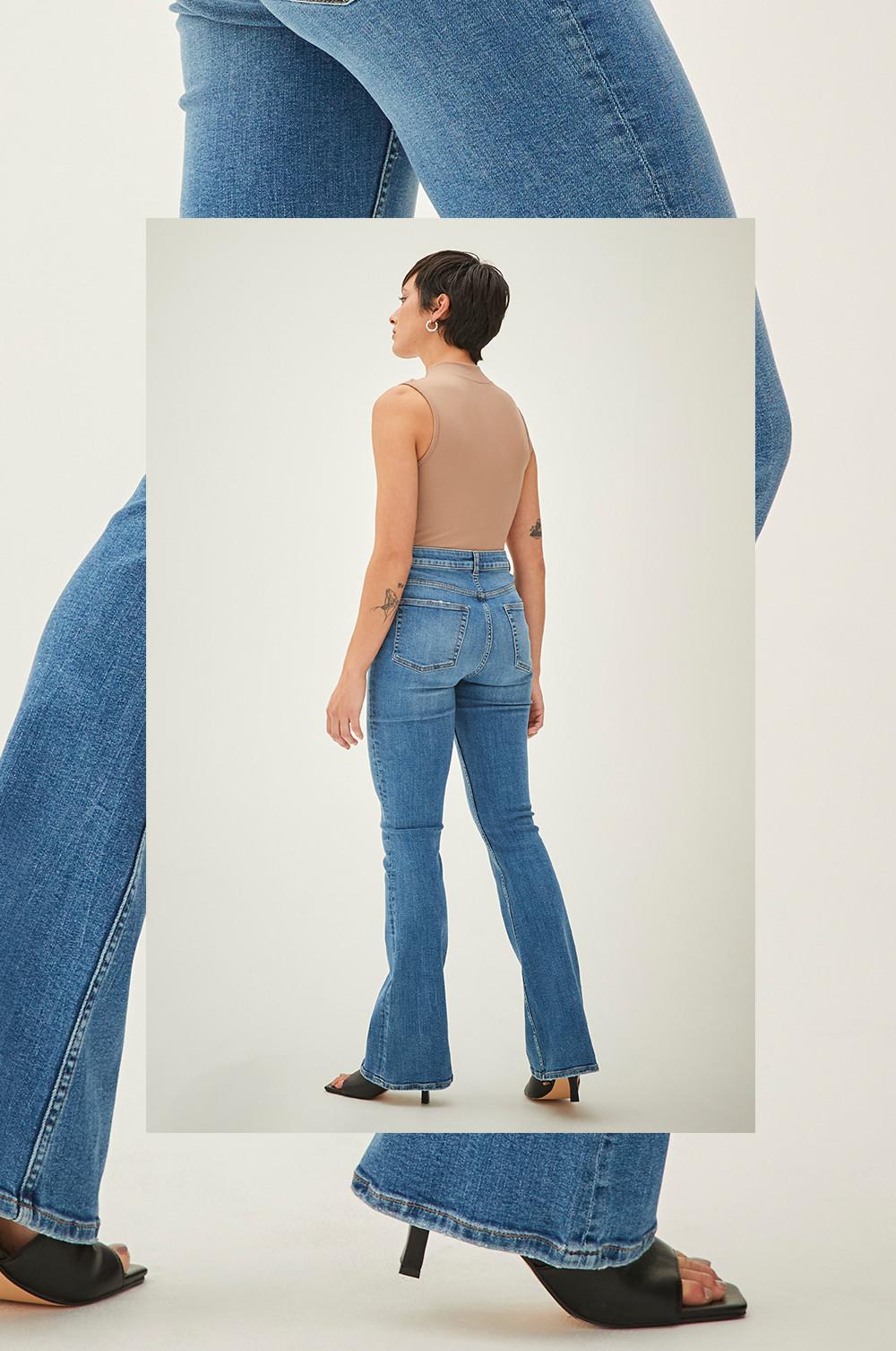 Model wears blue flared jeans