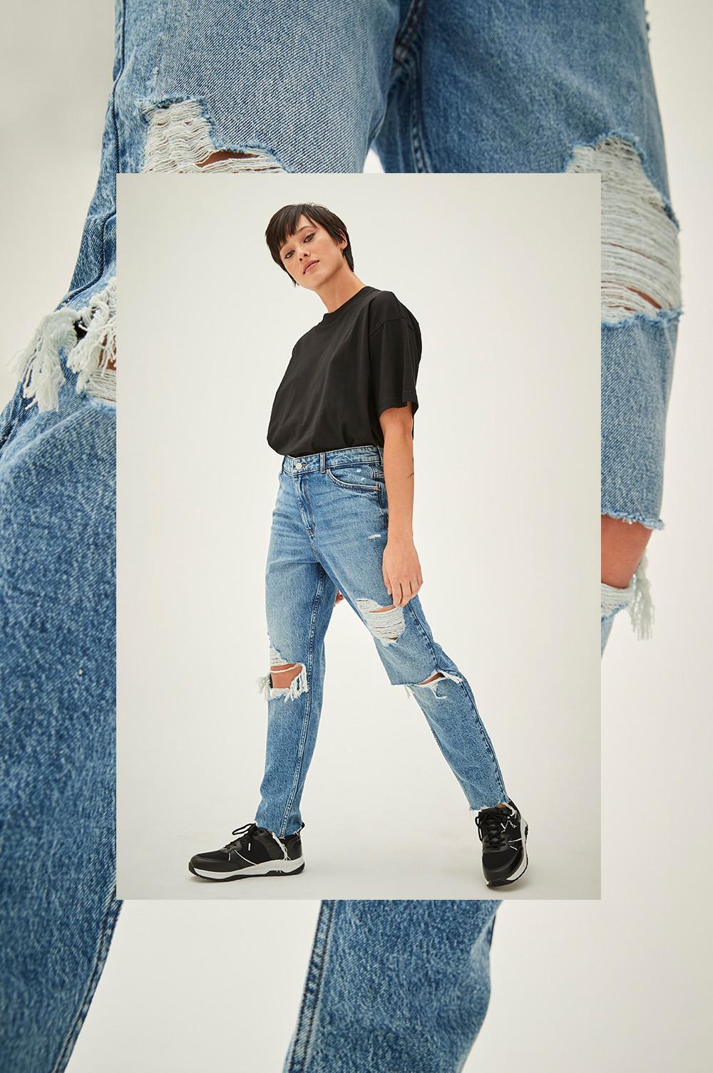 Model wears straight leg ripped jeans