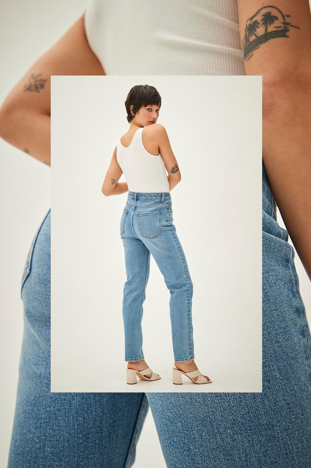 Model wears blue, slim straight jeans