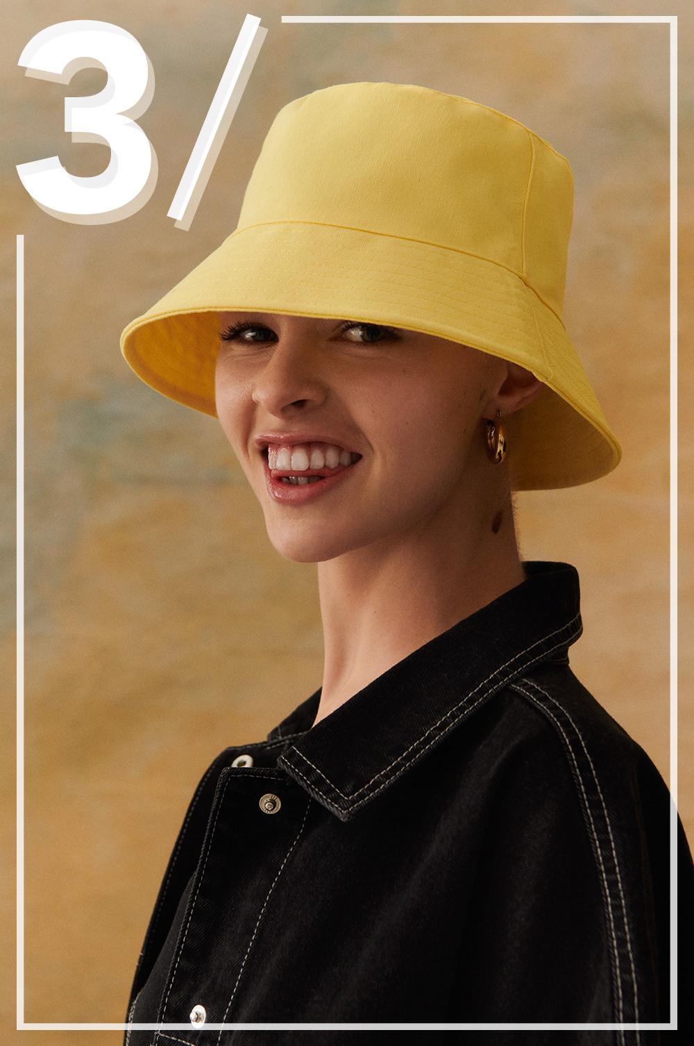 Model wearing a yellow bucket hat