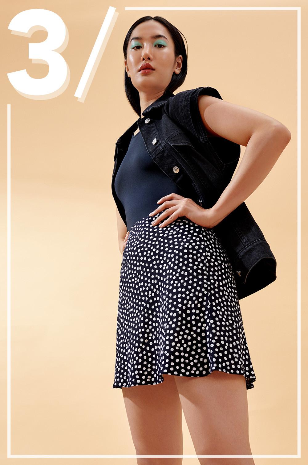 Model wears black and white floral skirt