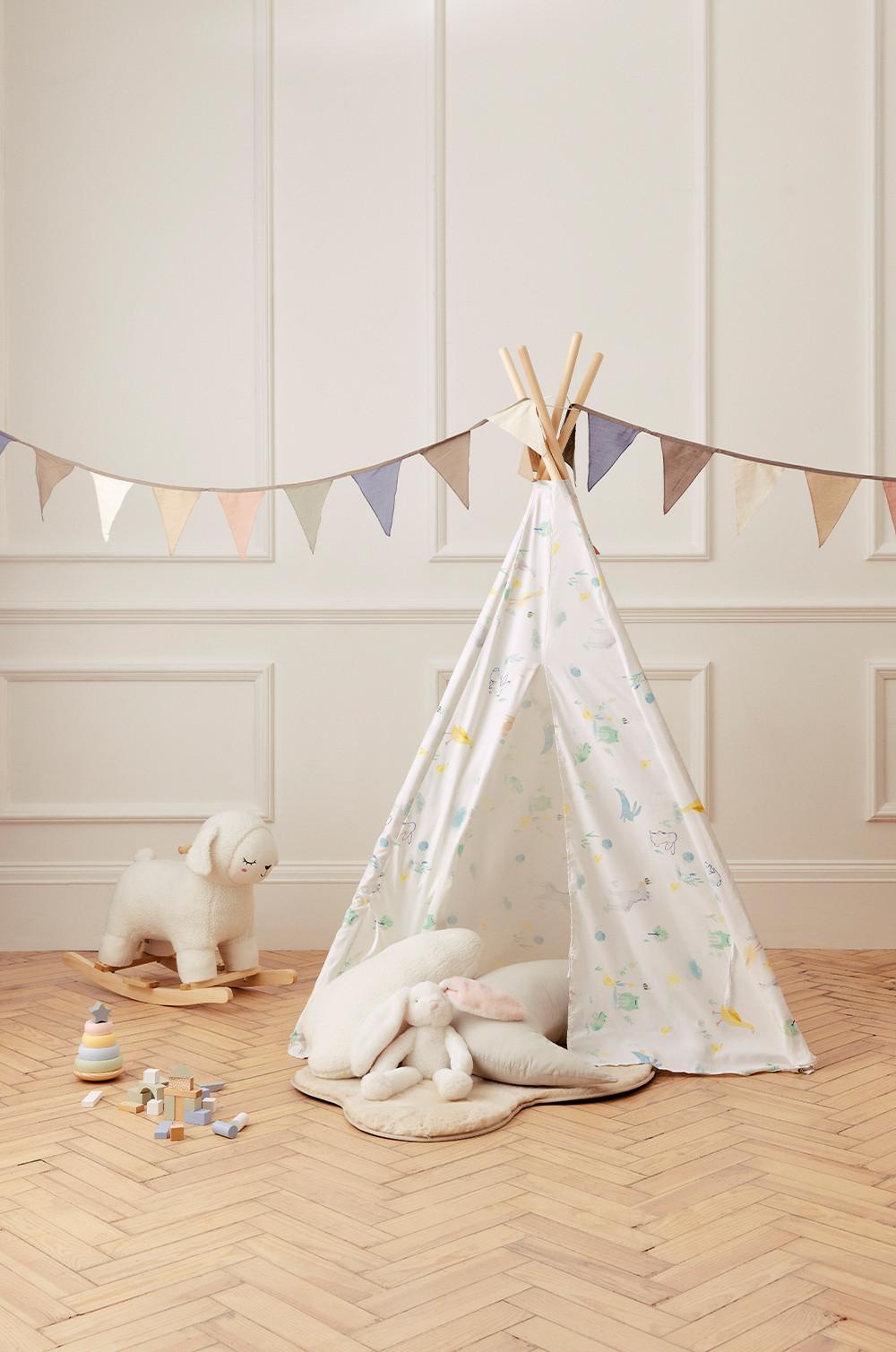 Nursery set up with teepee, rug and toys