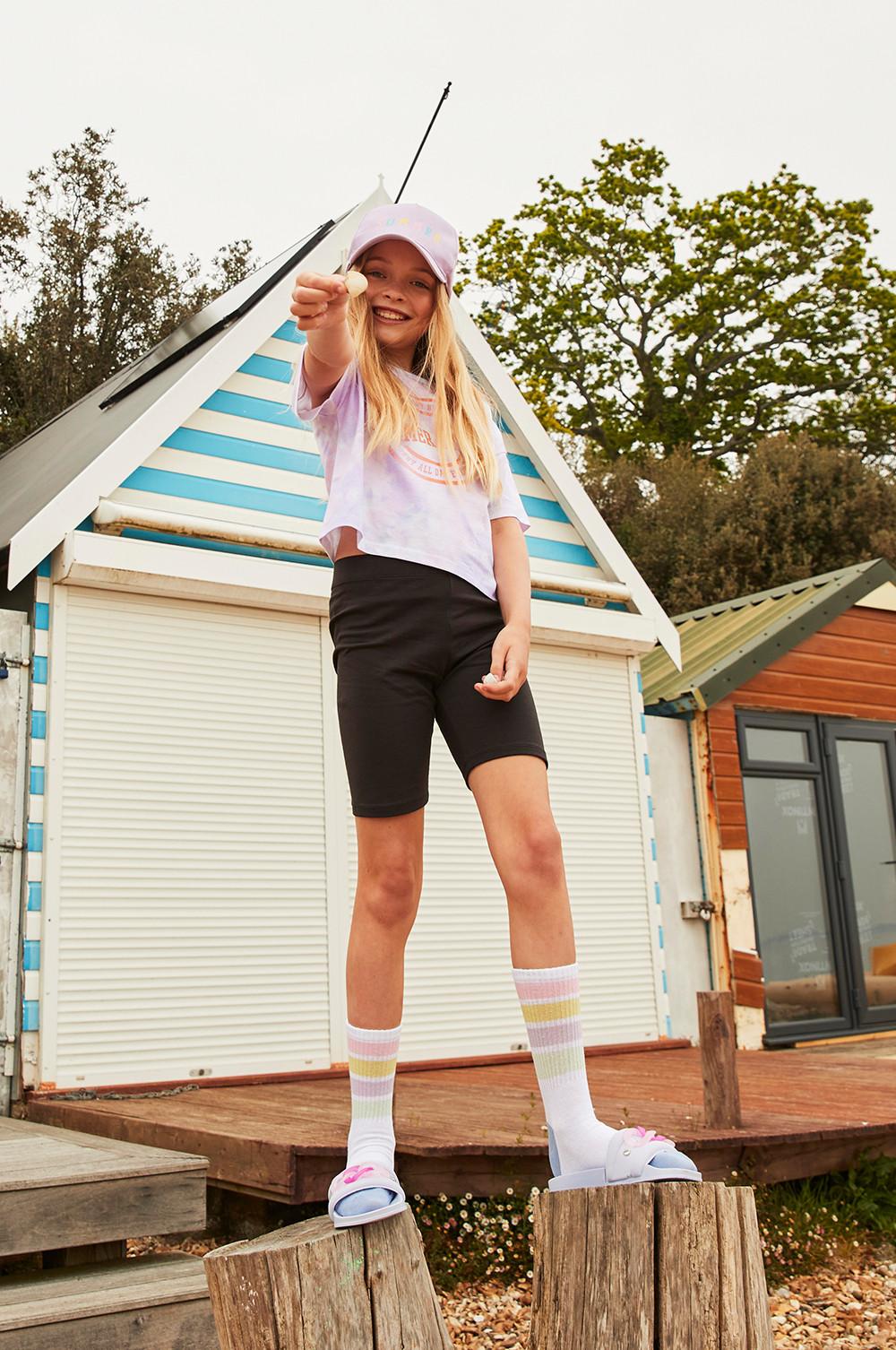 Child wears black shorts and tie-dye tshirt set