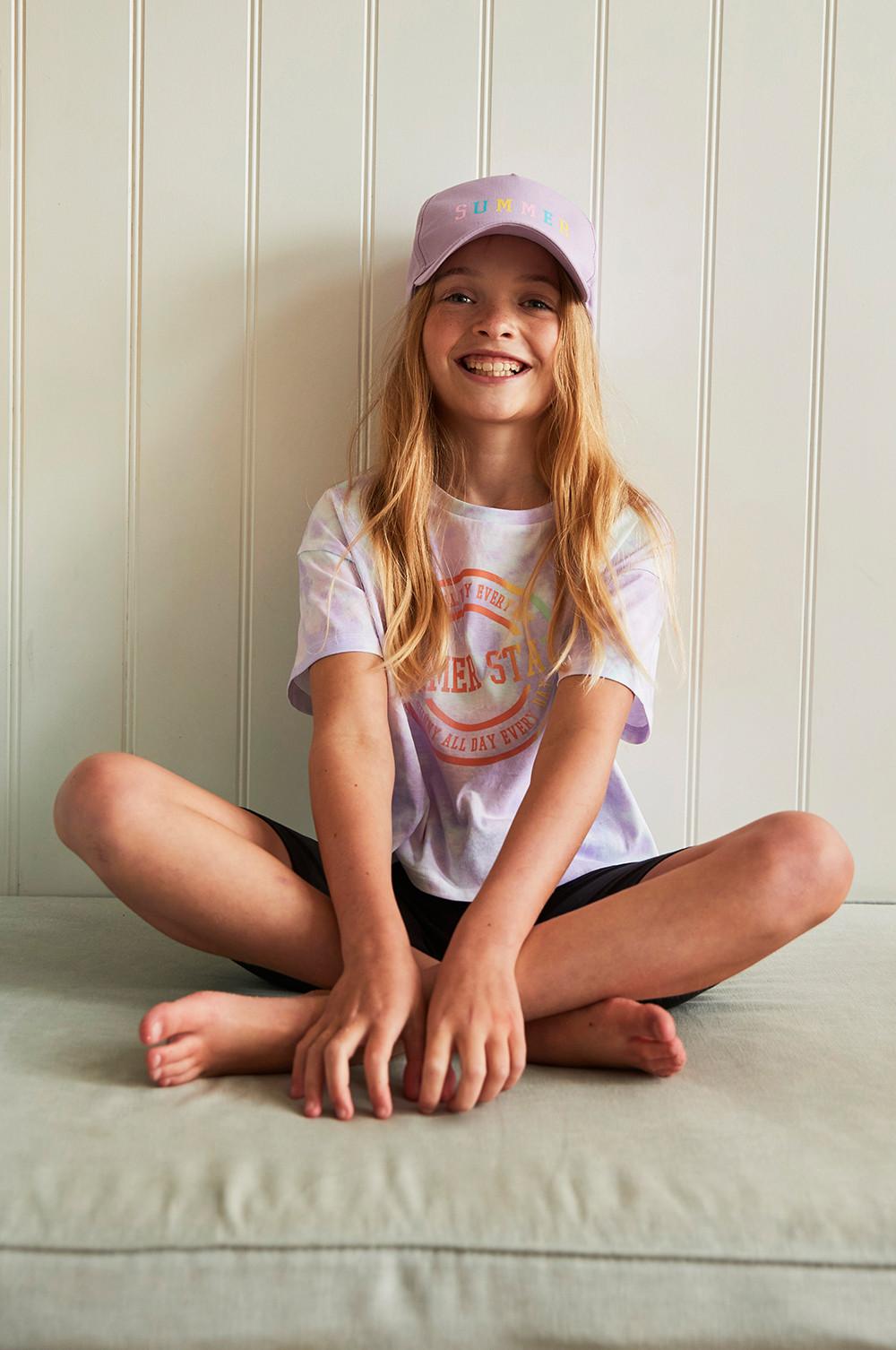 child wears lilac cap