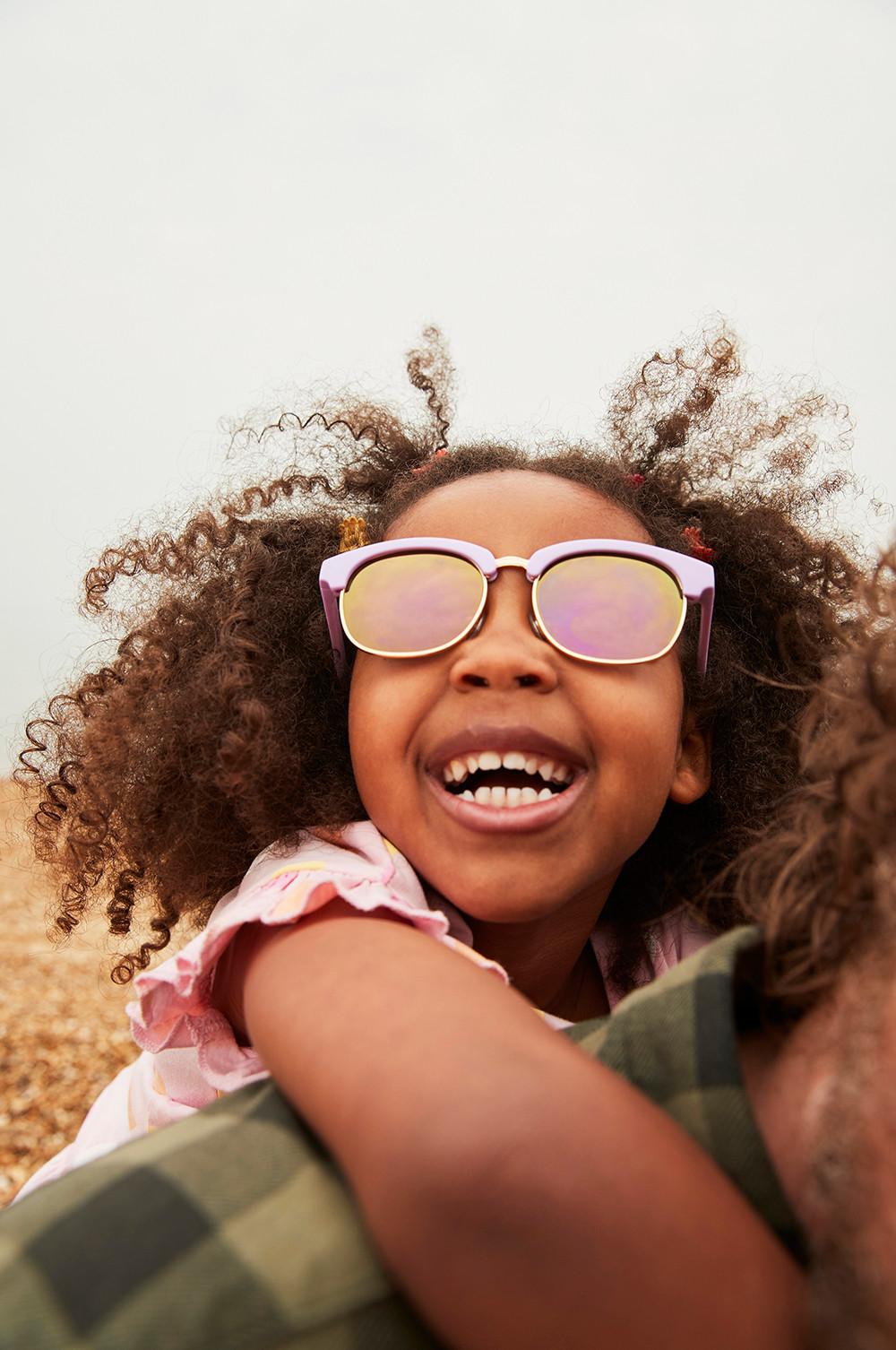 child wears sunglasses