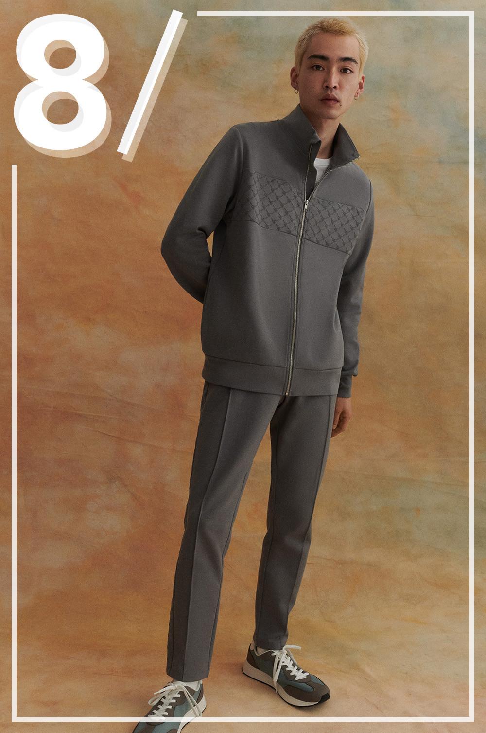 Model wears grey tracksuit