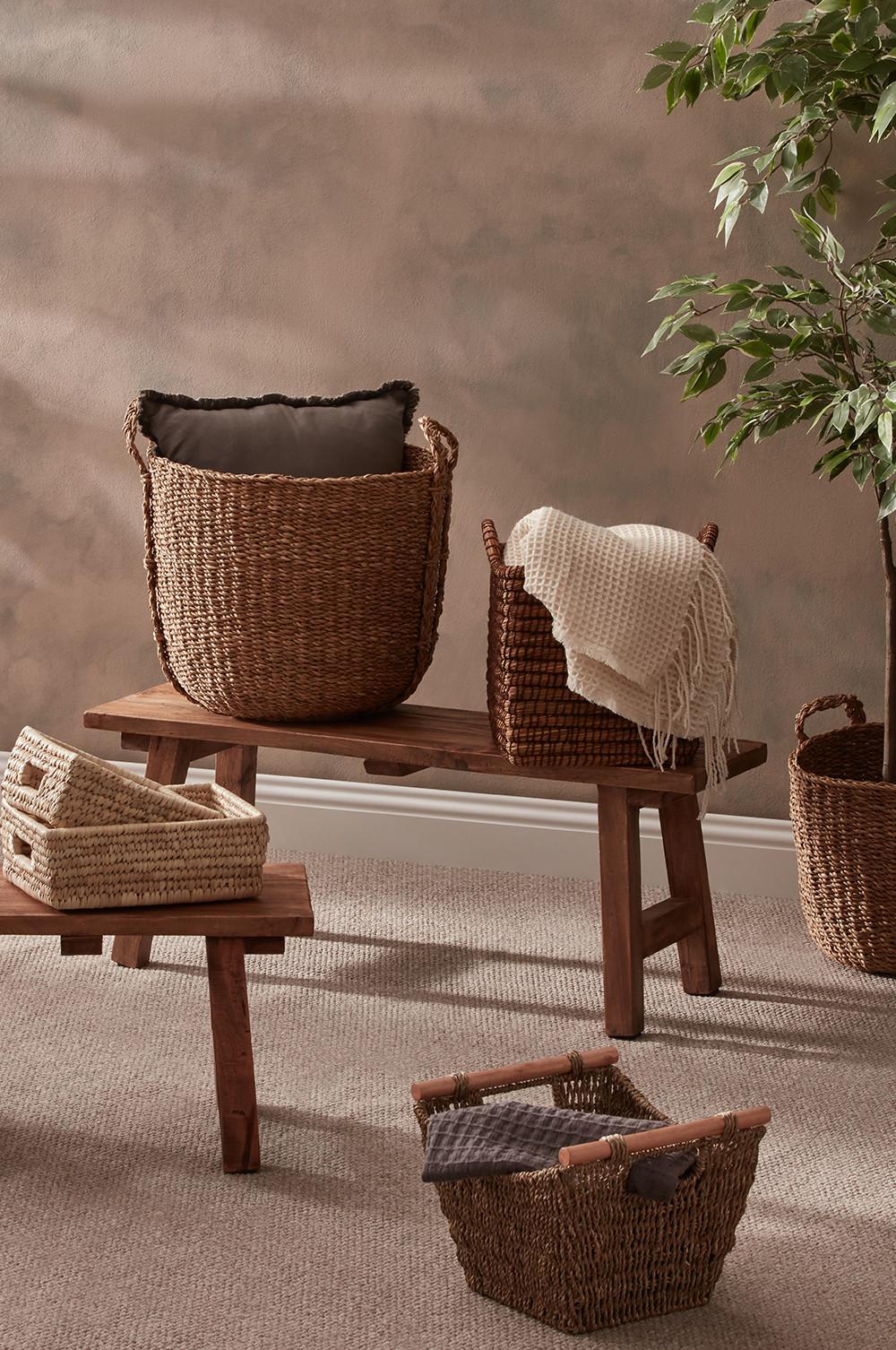 Storage baskets and blankets sit on wooden benches