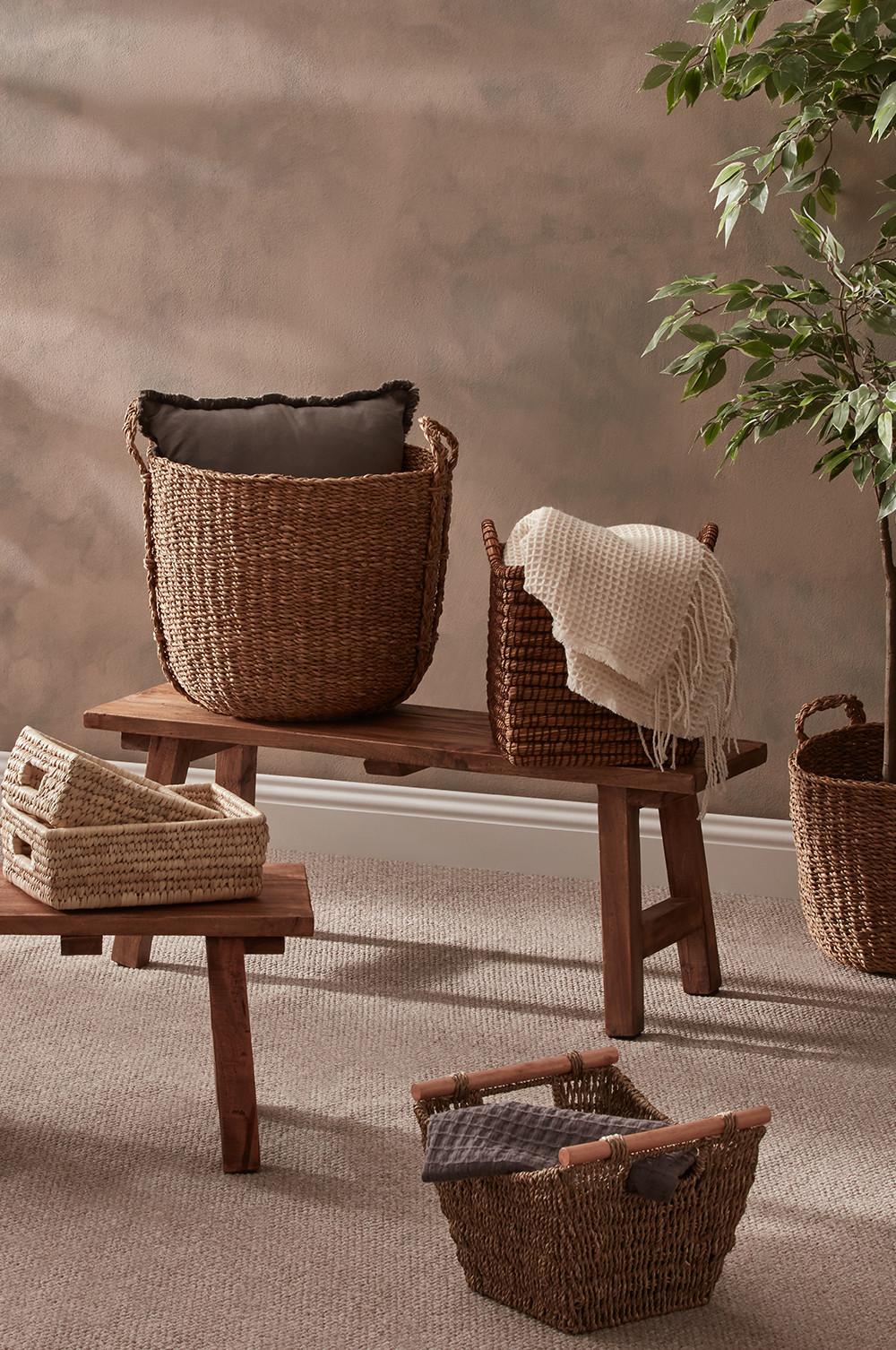 Storage baskets and blankets on wooden benches