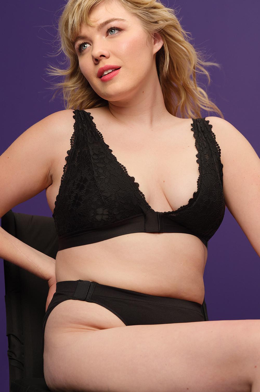 Modelo veste sutiã em renda adaptável preto, com fechos magnéticos à frente, combinado com cuecas sem costuras e fecho lateral pretas