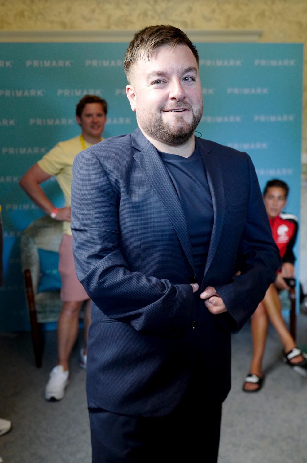 Alex wearing t-shirt and suit