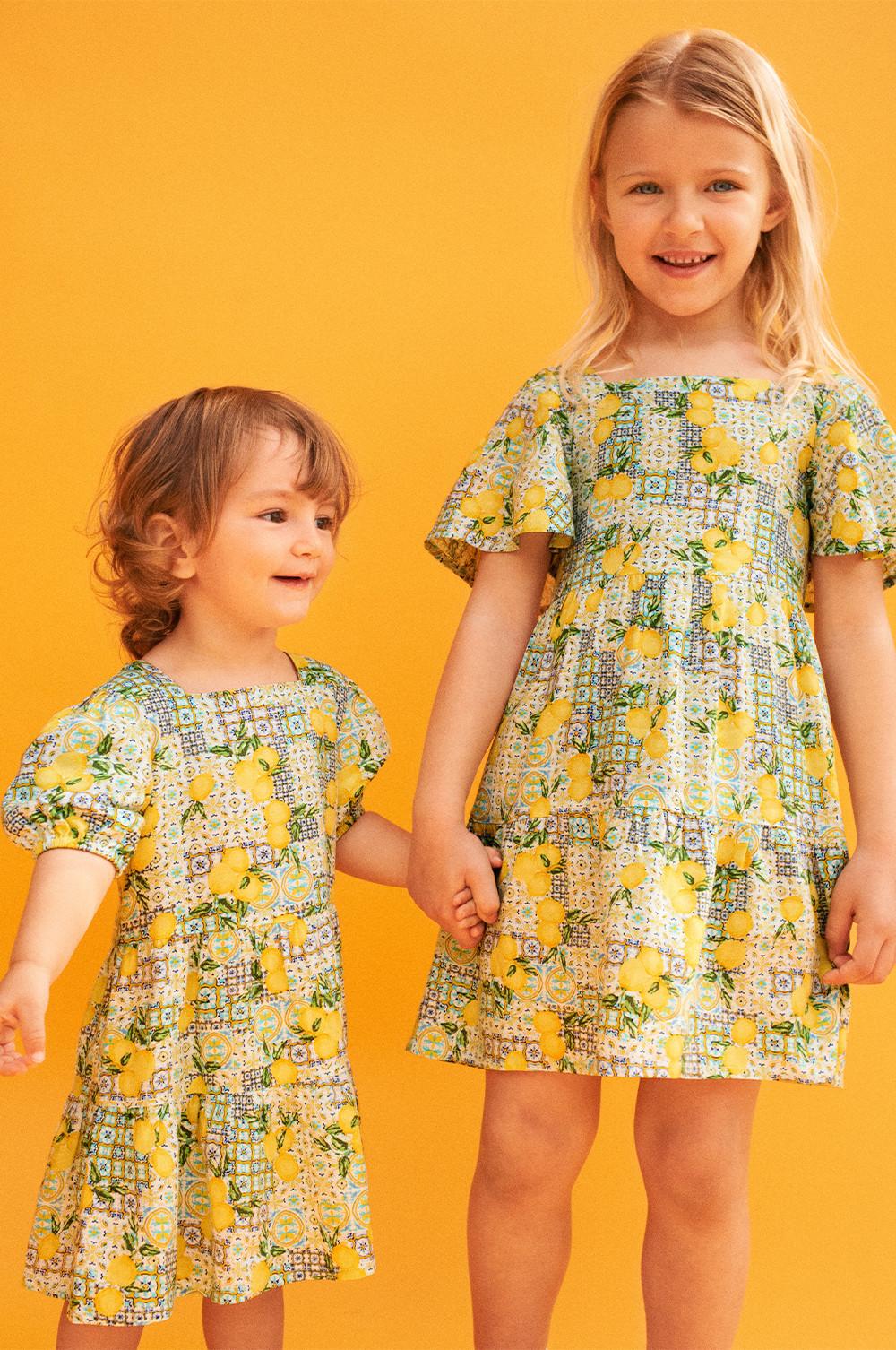 Models in lemon print dresses