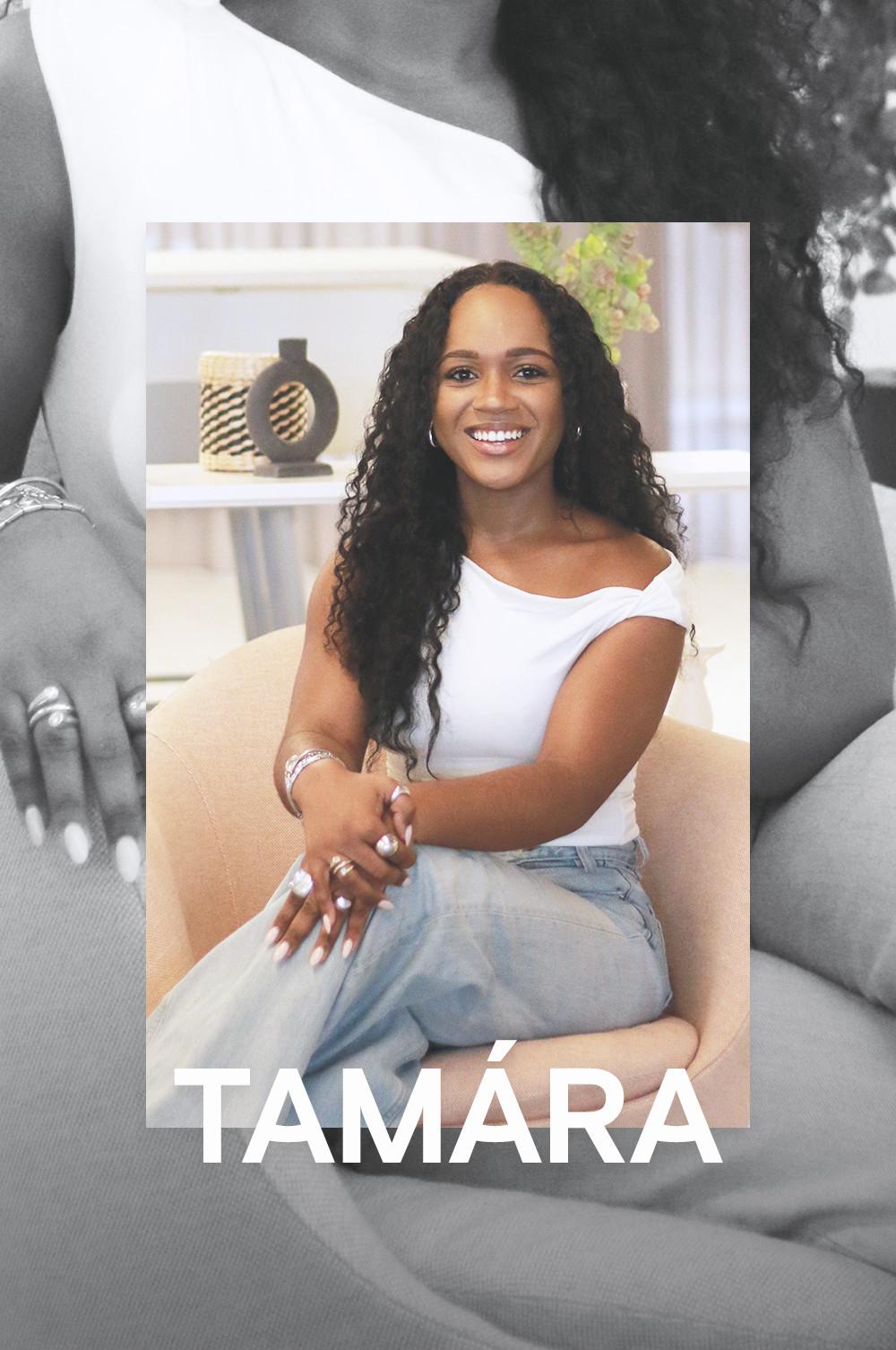 Tamára Tavares draagt ​​een grijze jeans en een witte top met blote schouder