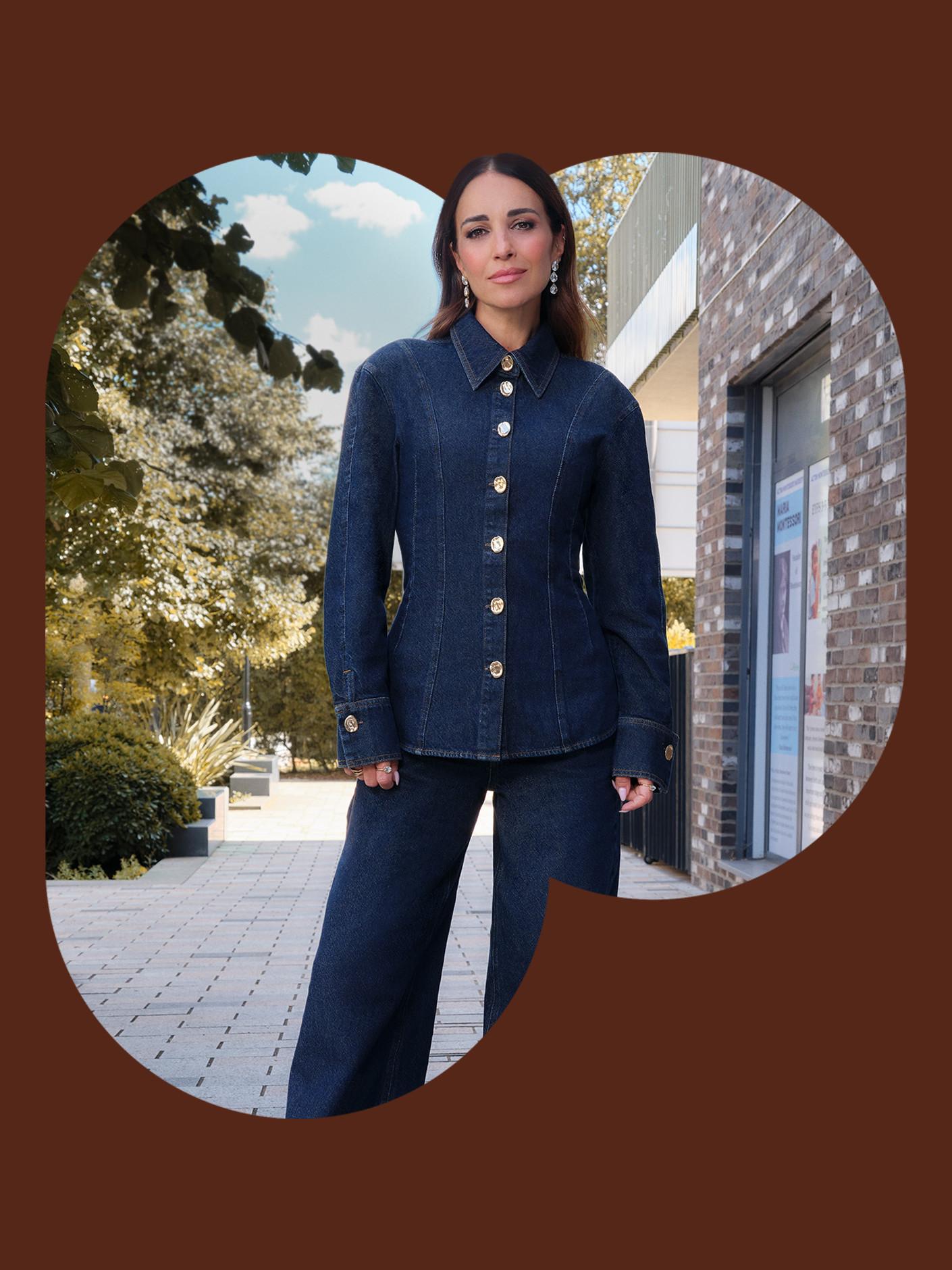 Person wearing stylish dark denim outfit with button-up jacket and wide-leg trousers outdoors.