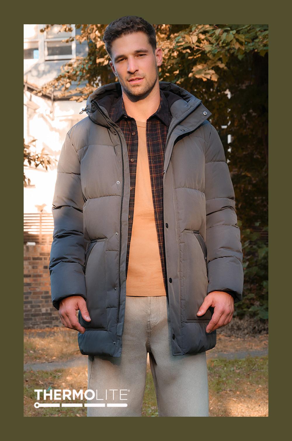 Gray padded puffer jacket worn over plaid shirt and orange top, with Thermolite branding visible.