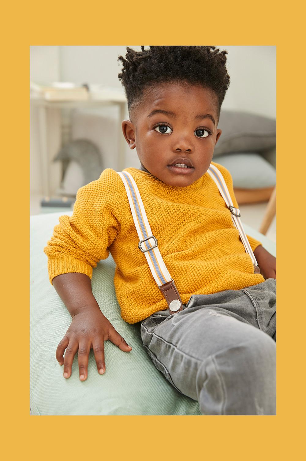 boy in yellow jumper and braces