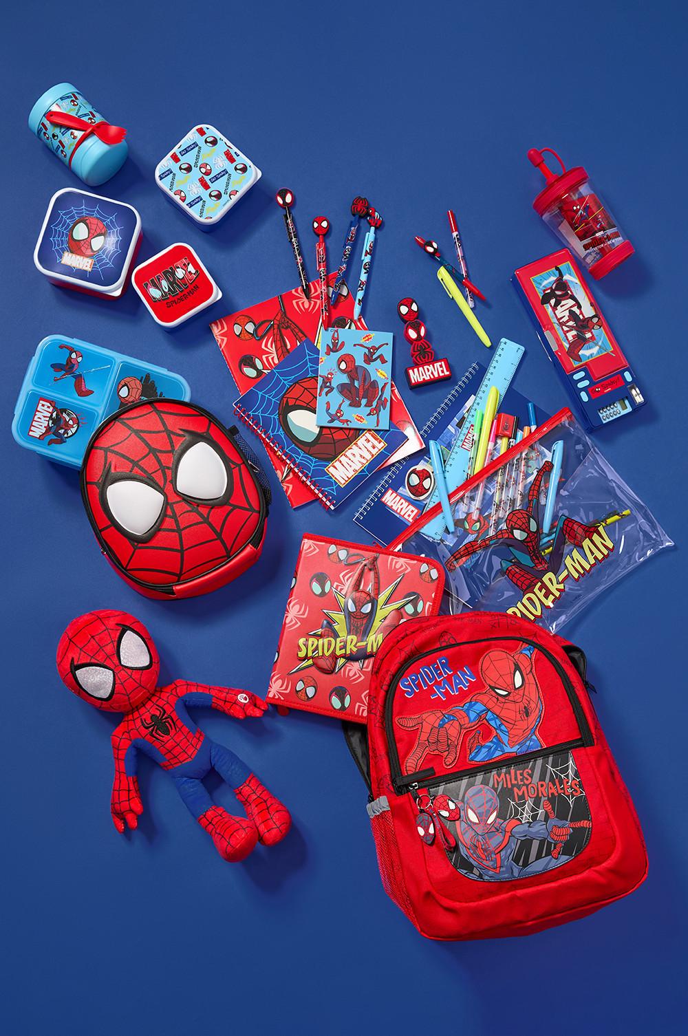Collection of Spider-Man themed school supplies including backpack, lunch containers, water bottle, stationery and plush toy arranged on blue background.