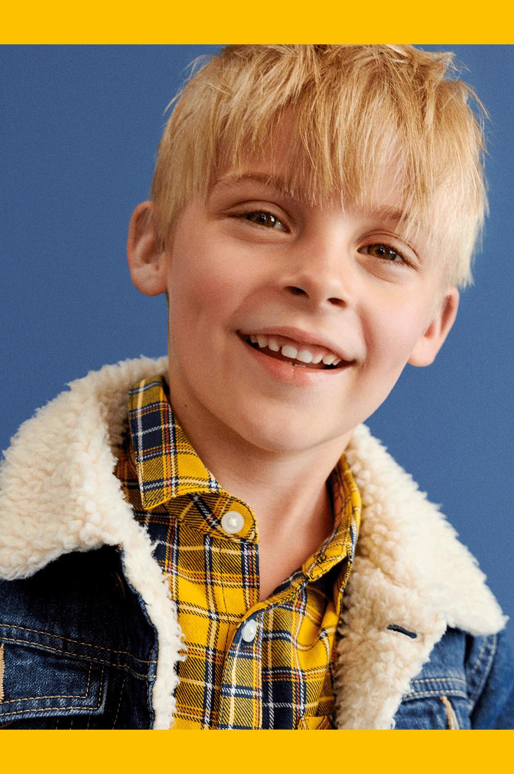 child in a denim jacket and yellow shirt