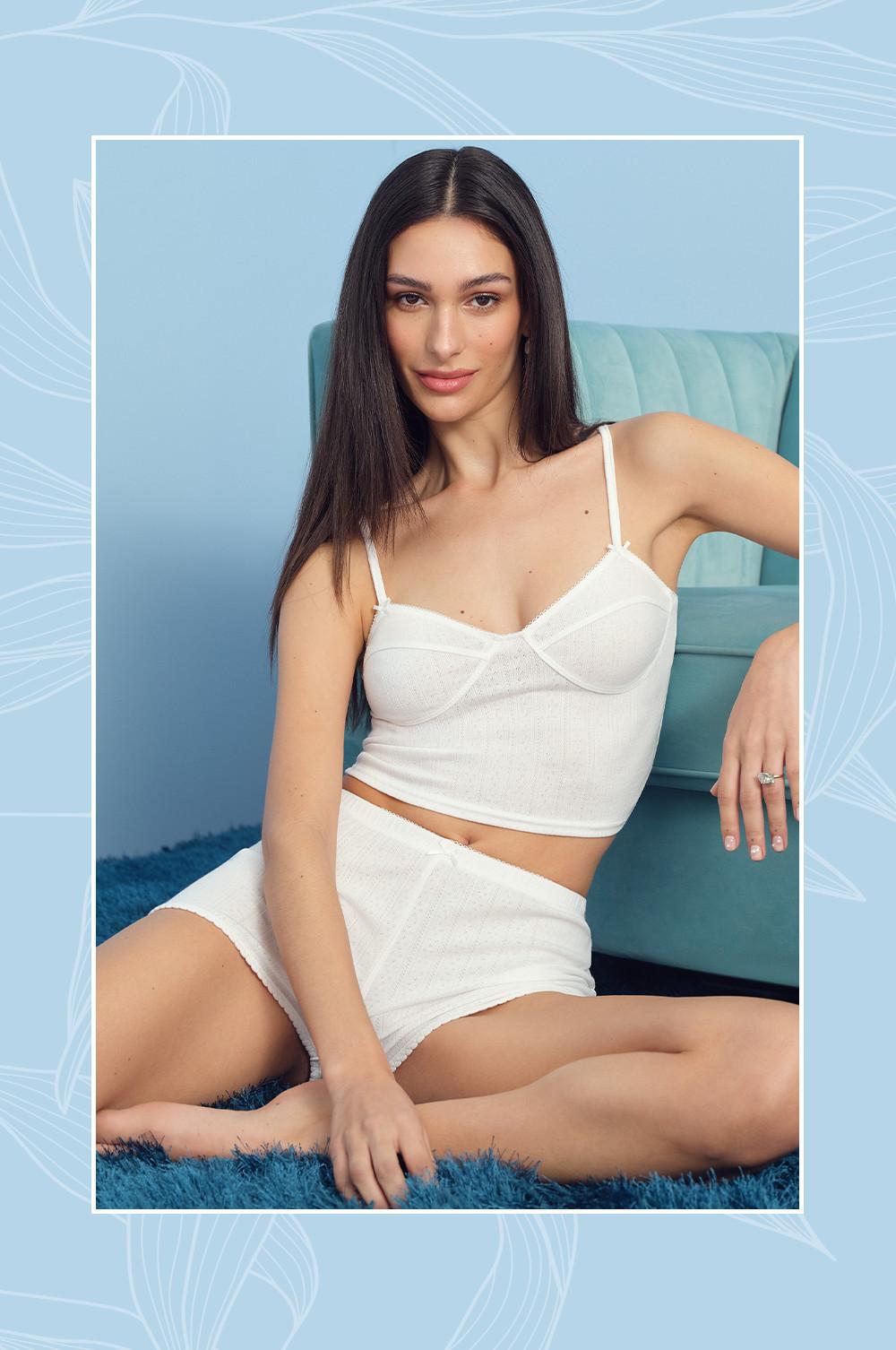 Model wearing white shapewear bra and shorts