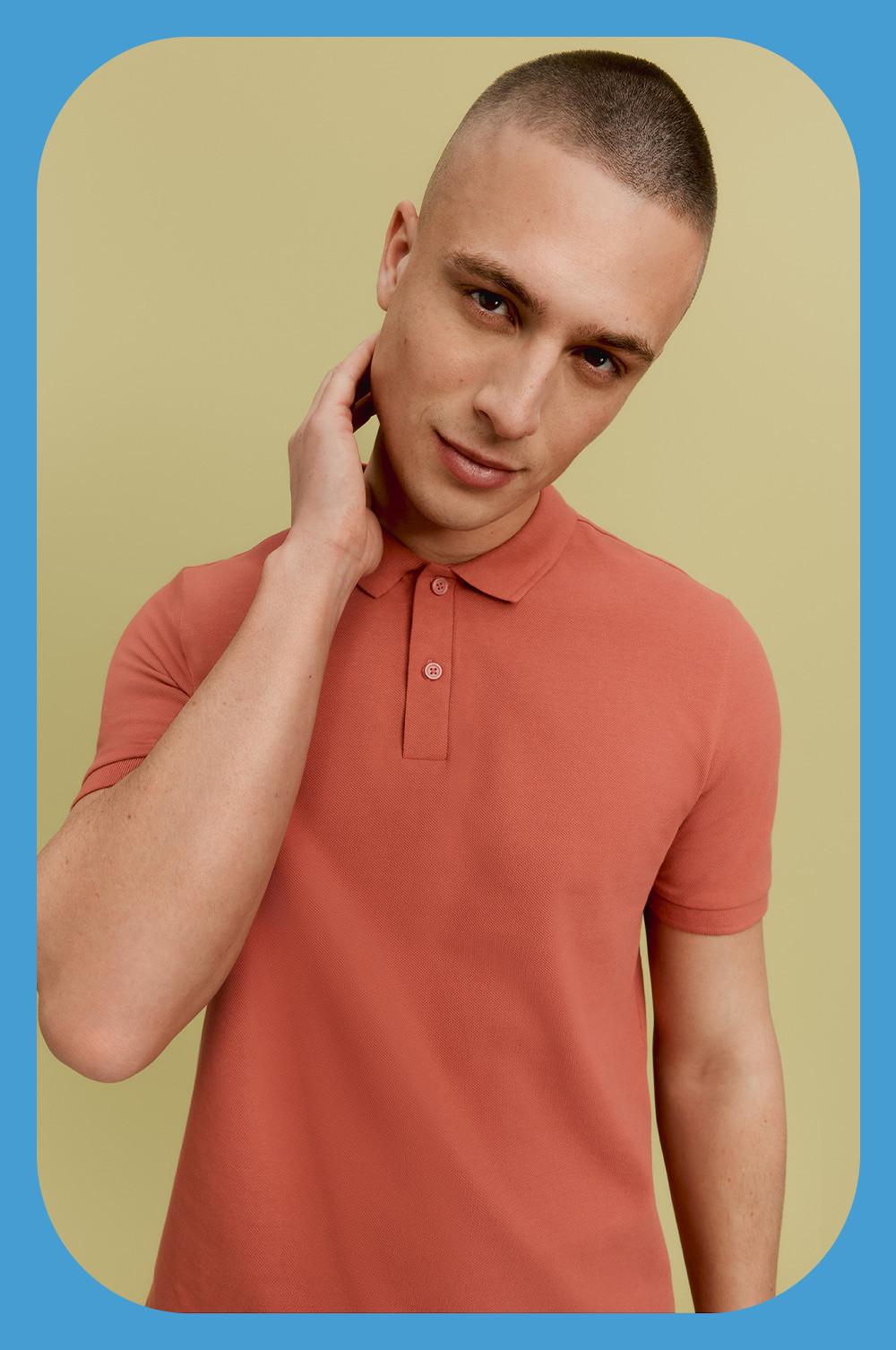 Model wearing polo shirt in orange