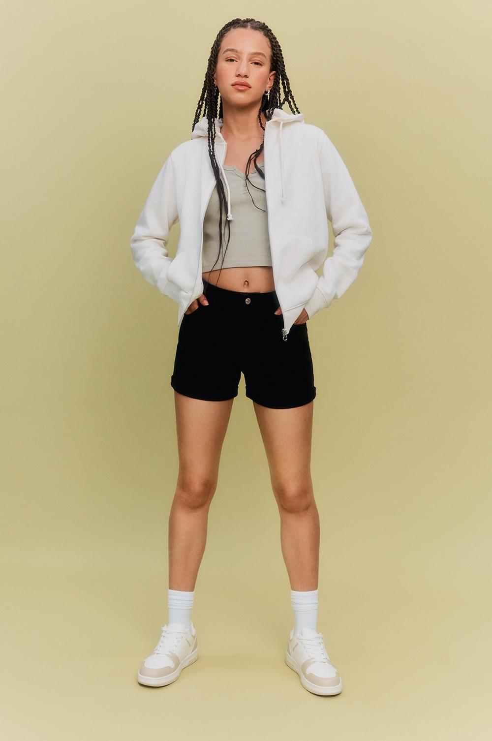 Model wearing shorts, hooded jacket in white and grey vest top