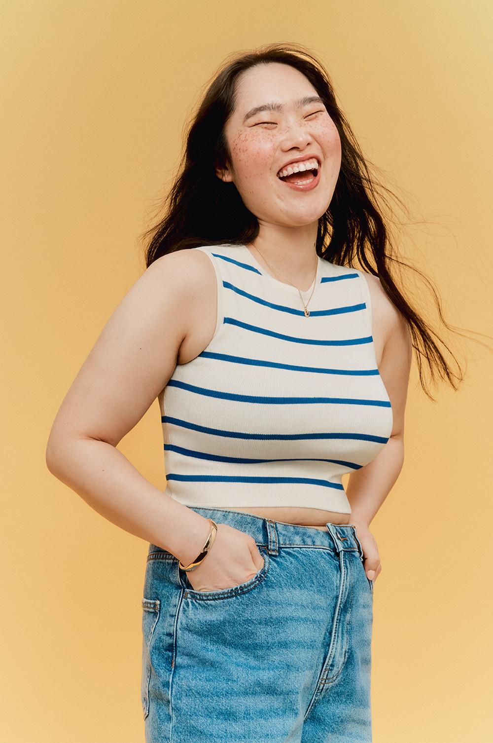 Model wearing striped top with blue jeans