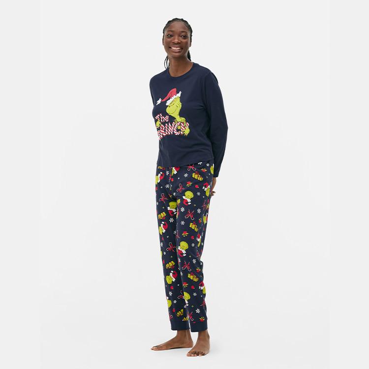 Navy Grinch Christmas pyjama set with long-sleeved top featuring Grinch graphic and matching patterned bottoms.