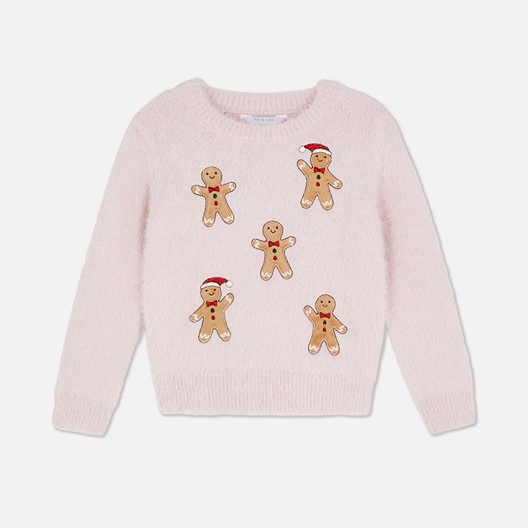 Pink knitted jumper featuring five gingerbread men decorations, some wearing Santa hats and bow ties.