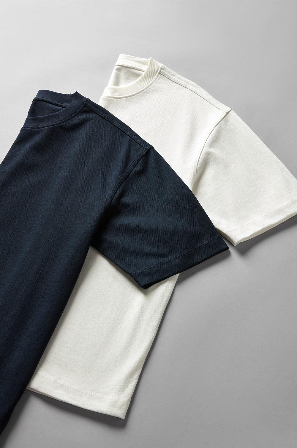Two folded t-shirts in white and navy