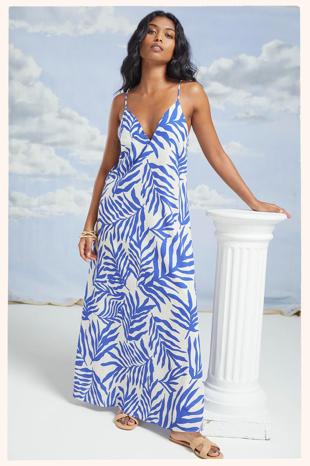 Model in blue/white print dress