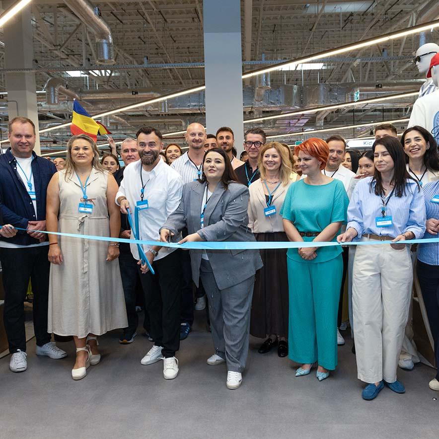 A group of individuals cutting a ribbon to celebrate the grand opening of a new store.