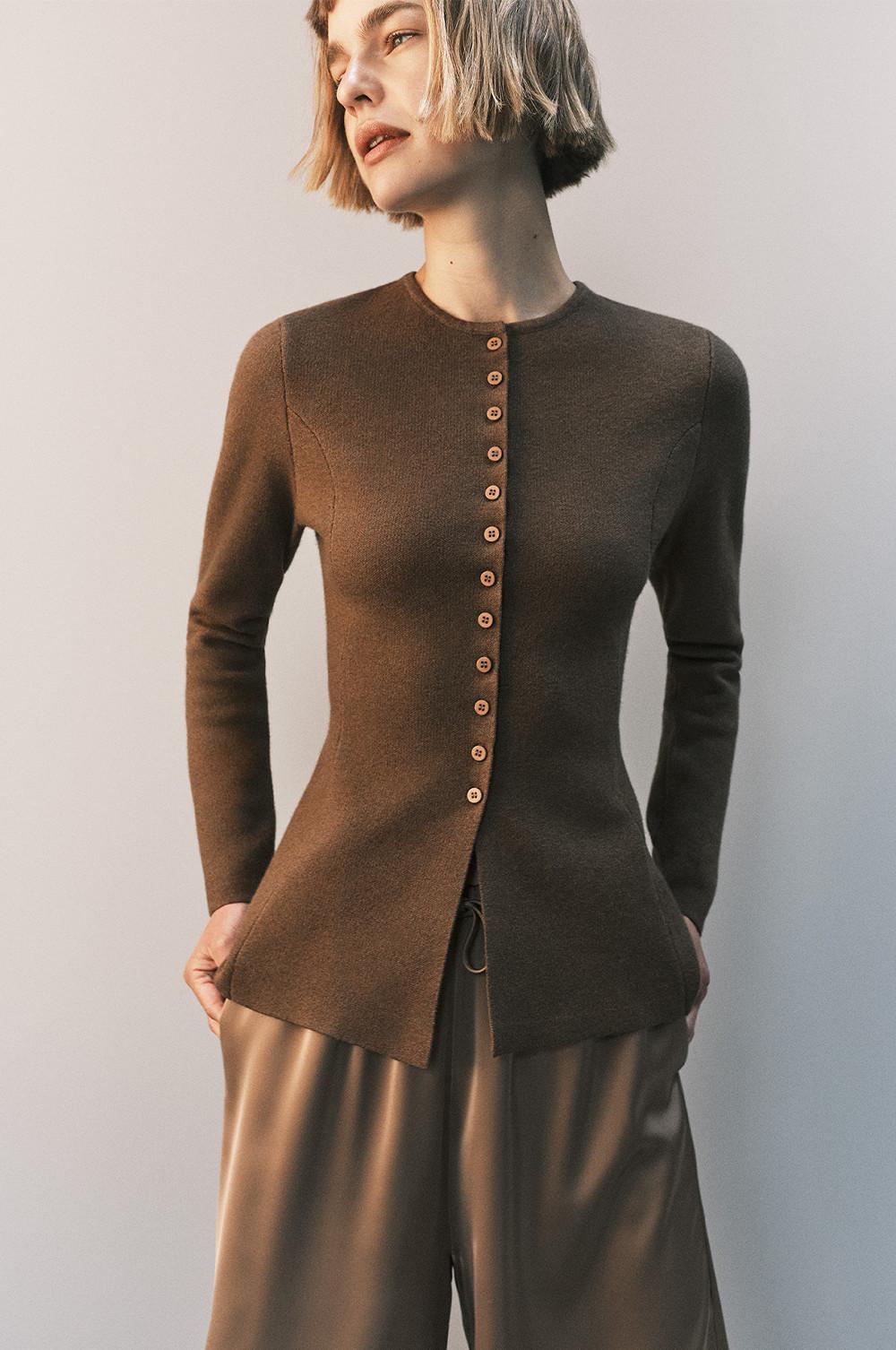 Brown fitted cardigan with vertical button closure and round neckline, paired with silky wide-leg pants.