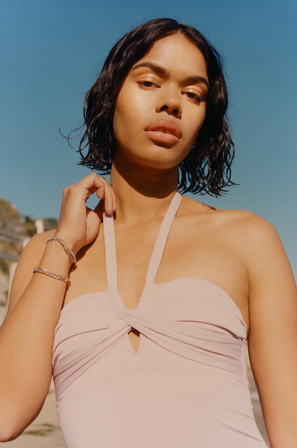 Model wears dusty pink mutli-way swimsuit