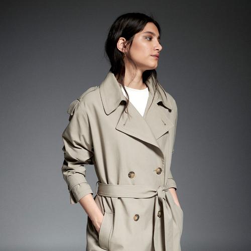 Model wears beige trench coat