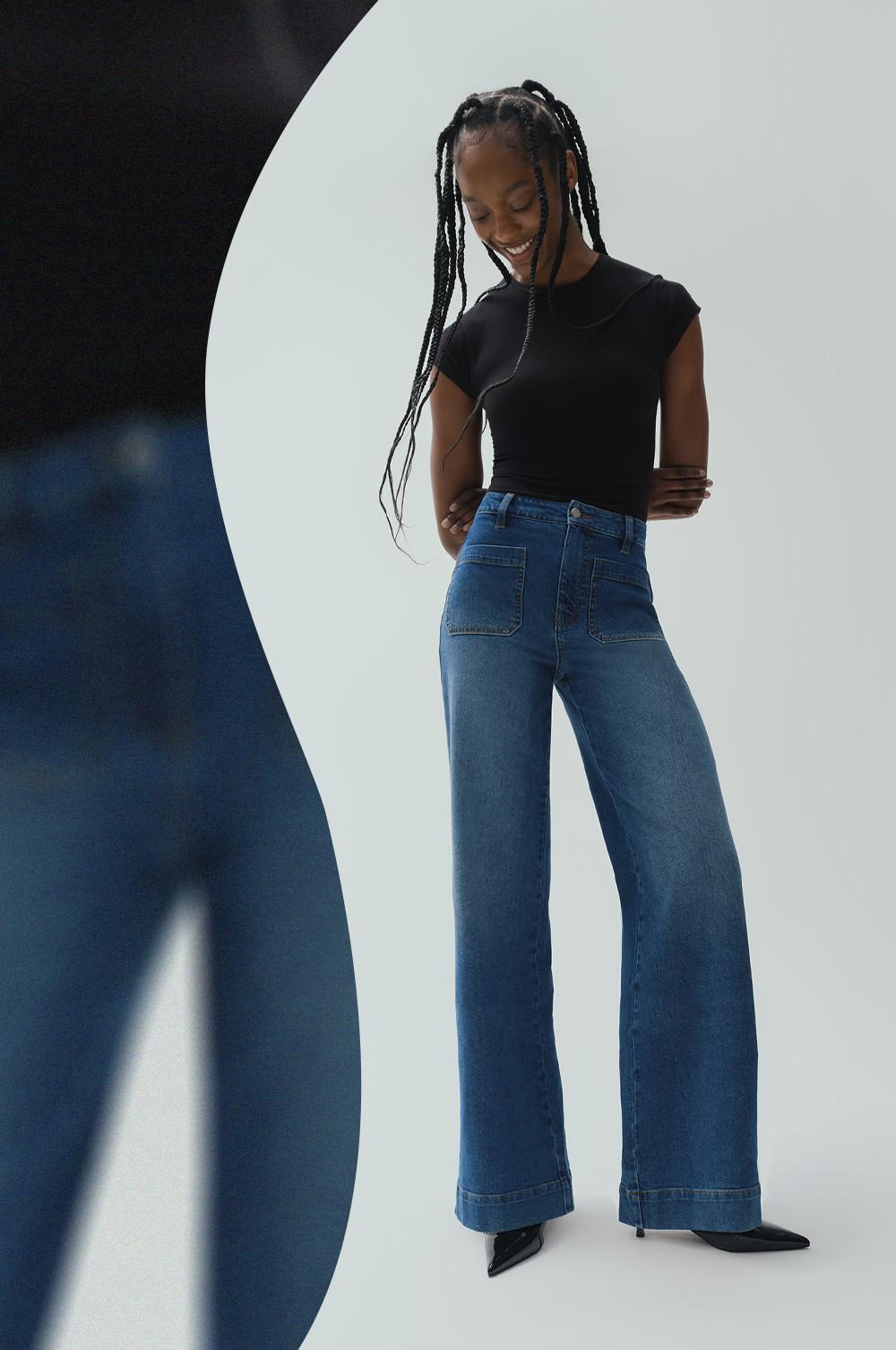 Model wearing black cropped T-shirt and blue wide-leg jeans with patch pockets, styled with black boots.