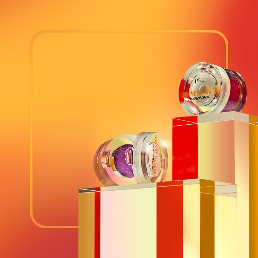 Chromfarbener Lidschatten in Silber und Violett auf einem Aufsteller mit orange/rotem Hintergrund.