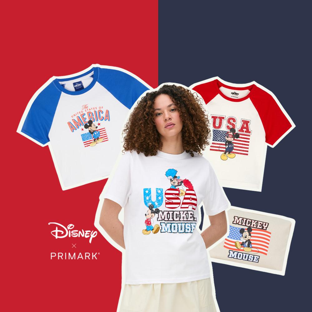 Model wearing white USA Disney T-shirt and cream skirt. White USA T-shirts in the background and cream Mickey Mouse makeup bag.