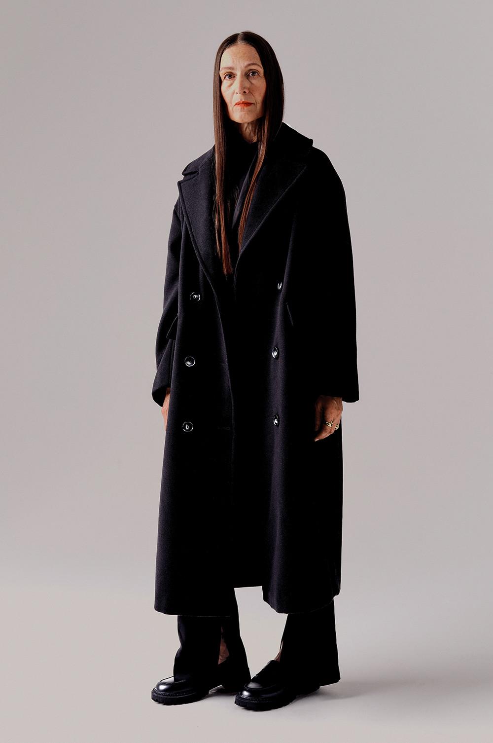 model wears black duster coat