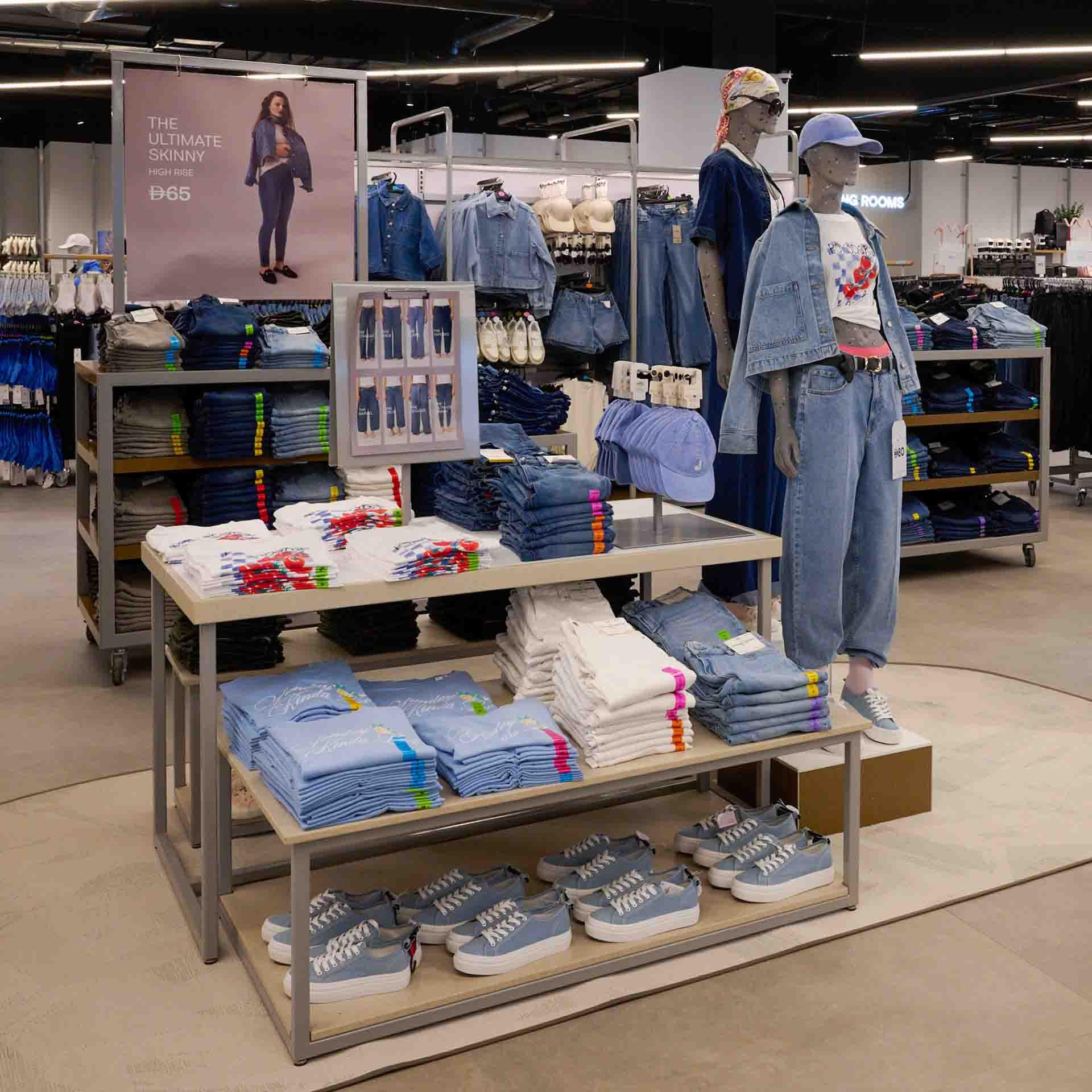 Mannequins wearing denim outfits are displayed in a Primark store.